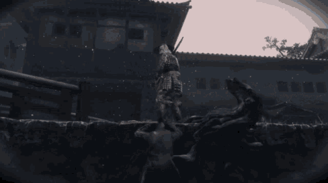 a samurai is fighting a monster in front of a building .