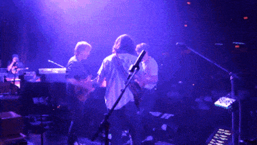 a group of people playing instruments on a stage