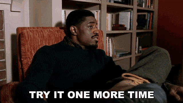 a man sits in a chair with the words " try it one more time " behind him