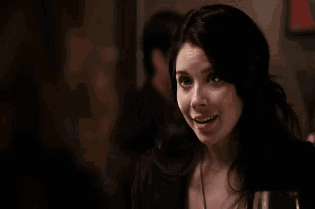 a woman is making a funny face while looking at another woman