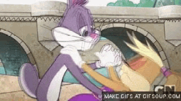 bugs bunny and lola bunny are dancing together in a cartoon .