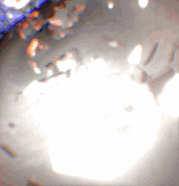a blurred image of a white background with a few spots of light on it