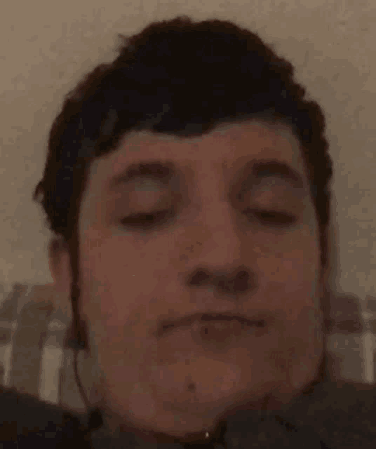 a close up of a person 's face with headphones on
