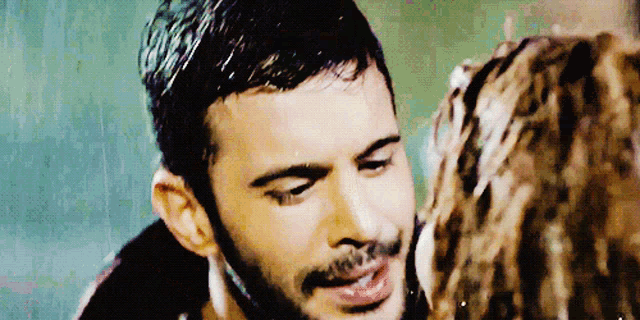a close up of a man 's face with his eyes closed