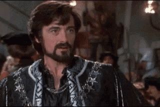 a man with a beard wearing a black and white jacket with stars on it .