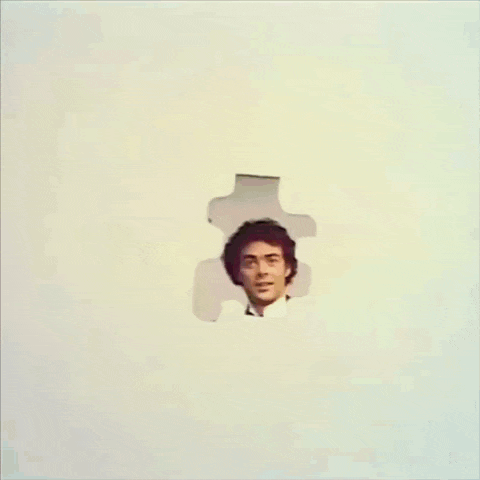 a group of people standing in front of a large puzzle piece