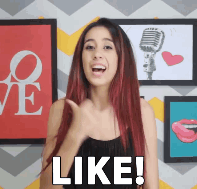 a woman with red hair is giving a thumbs up and the word like is on the screen