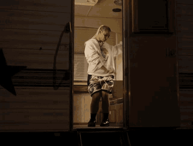 a woman standing in front of a trailer that says u.s.a. on it