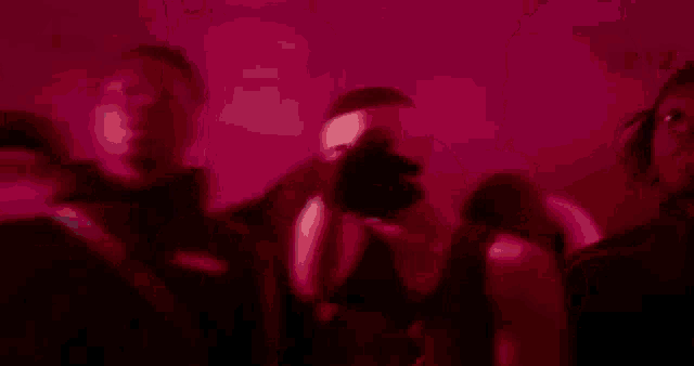 a group of people dancing in a dark room