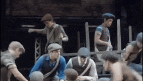 a group of men are sitting on a stage playing a musical .