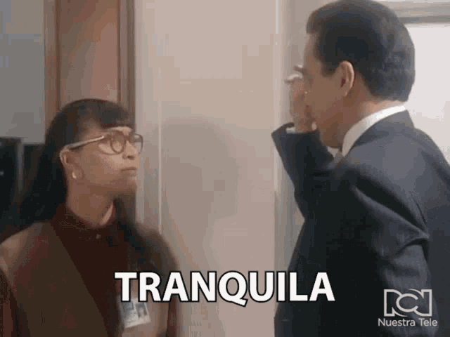 a man and a woman standing next to each other with tranquila written on the bottom right