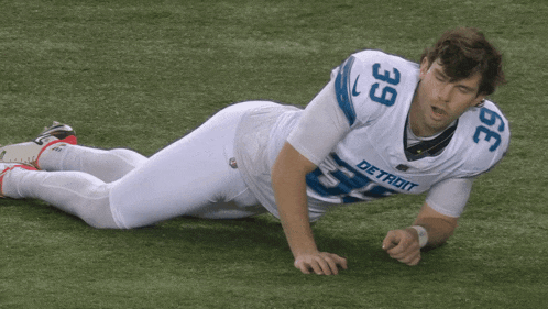 a detroit football player is laying on the ground