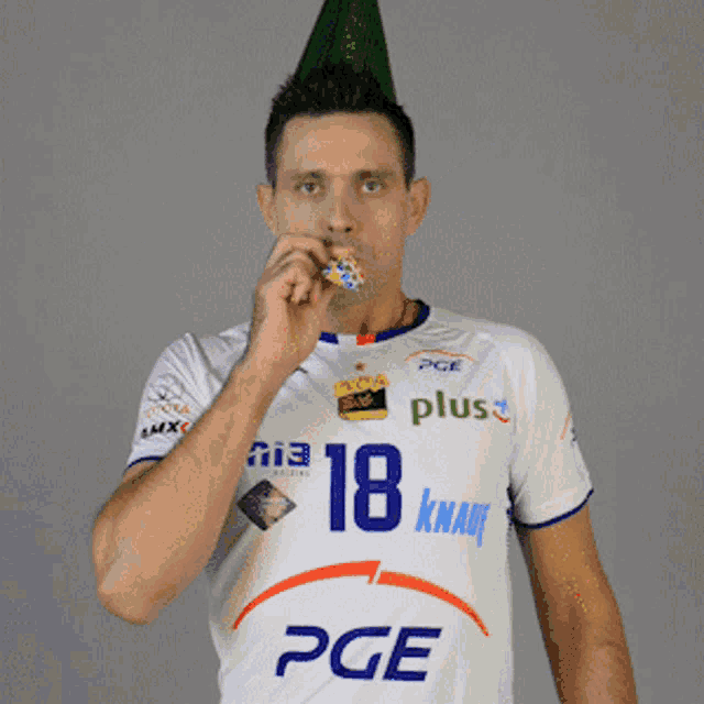 a man wearing a white pge shirt with the number 18 on it
