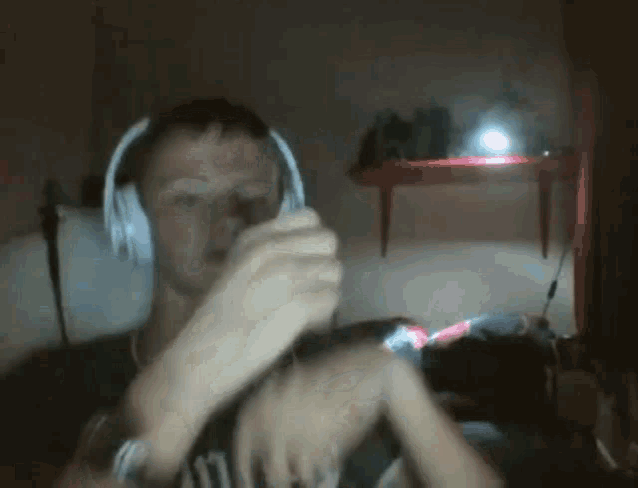 a man wearing headphones and a watch is playing a game