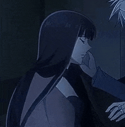 a man and a woman are hugging each other in the dark .