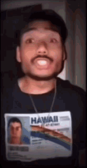 a man with a hawaiian id on his shirt
