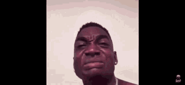 a young man is making a funny face with his mouth open and his eyes closed .