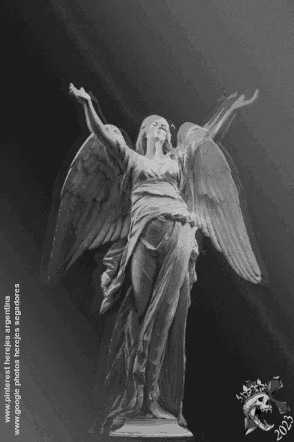 a black and white photo of a statue of a woman with wings