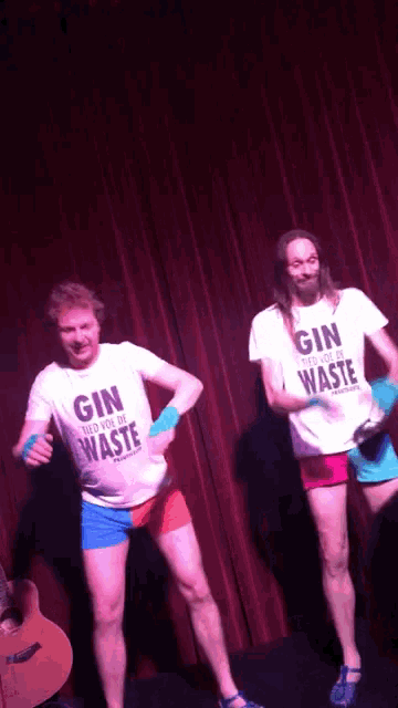 two men wearing shirts that say gin and waste