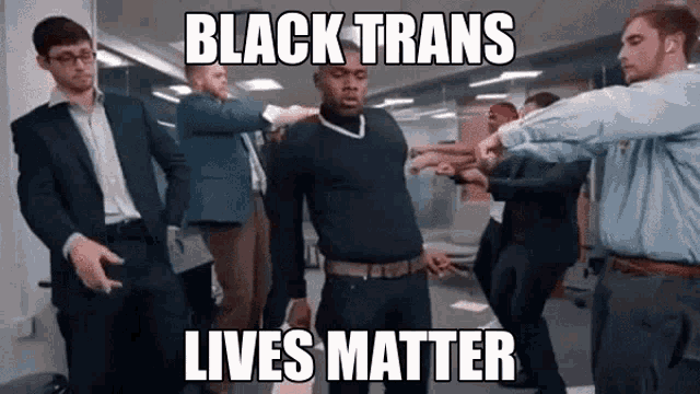 a group of men are dancing in a room with the caption black trans lives matter .