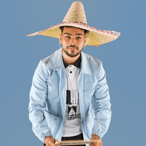 a man wearing a sombrero is holding a chalkboard that says gg on it