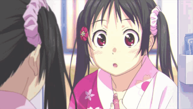 a girl with pigtails and a flower in her hair is looking at herself in the mirror