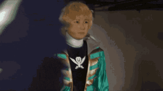 a man in a green and gold jacket with a skull and crossbones on it
