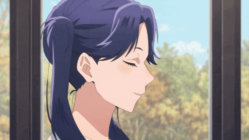 a woman with a ponytail looks out a window