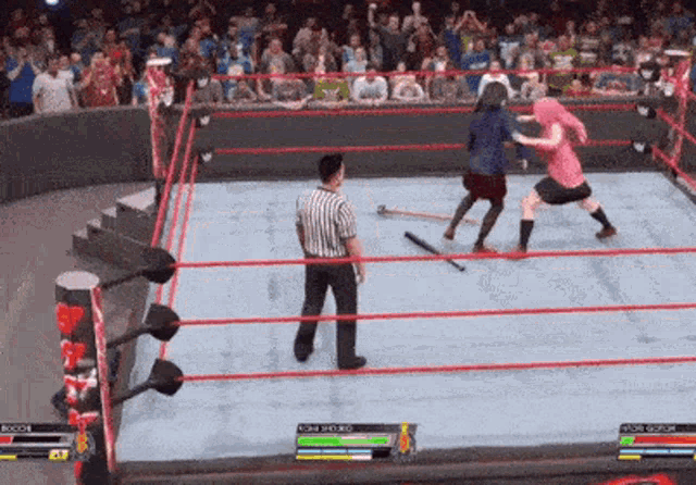 a video game is being played on a wrestling ring with a referee