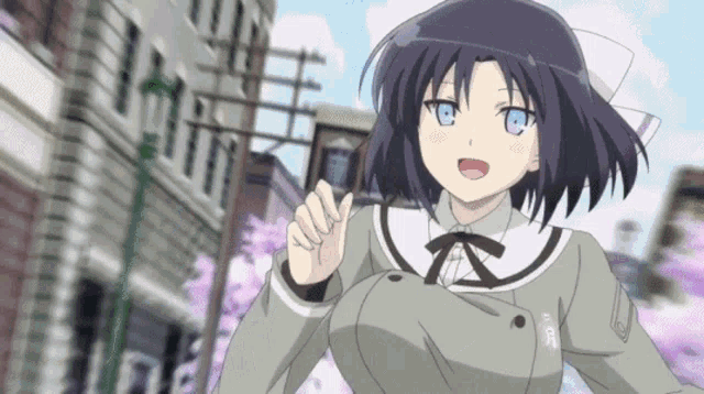 a girl with dark hair and blue eyes is walking down the street