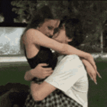 a man and a woman are hugging and kissing each other