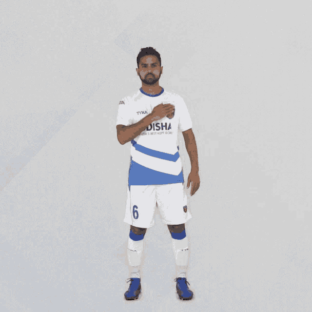a soccer player wearing a blue and white odisha shirt