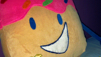 a stuffed ice cream cone with a smile on it