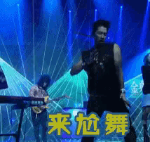 a man is dancing on a stage in front of a keyboard