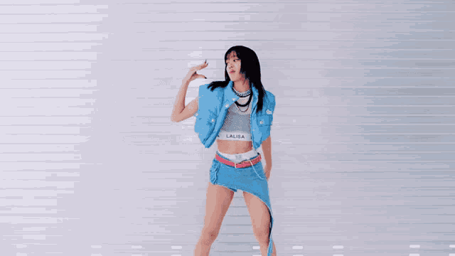 a woman wearing a lalisa top and skirt is dancing