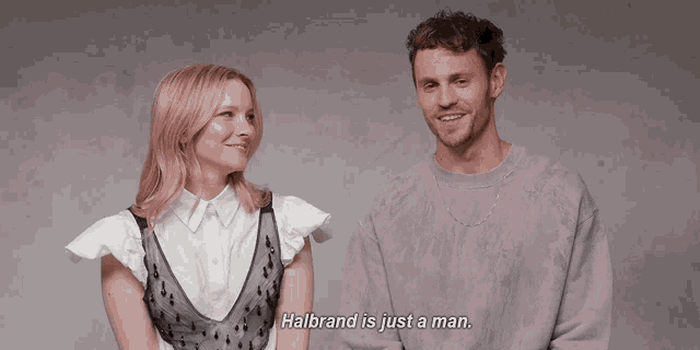a man and a woman are laughing and halbrand is just a man
