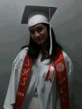 a woman wearing a cap and gown with a sash that says shs