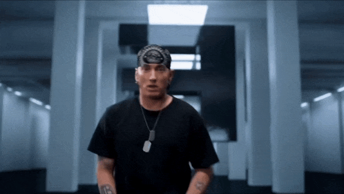 a man wearing a bandana and a necklace with a tag that says ' eminem ' on it