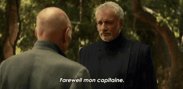 a man in a suit says farewell to another man