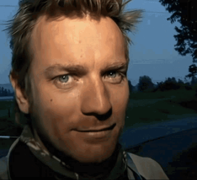 a close up of a man 's face with his eyes closed
