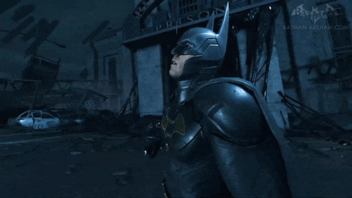 a man in a batman costume is standing in front of a building that says us on it