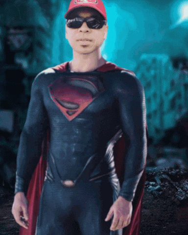 a man in a superman costume with a red cape and sunglasses