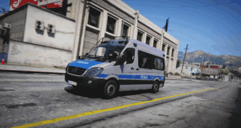 a police van drives down a street in front of a building