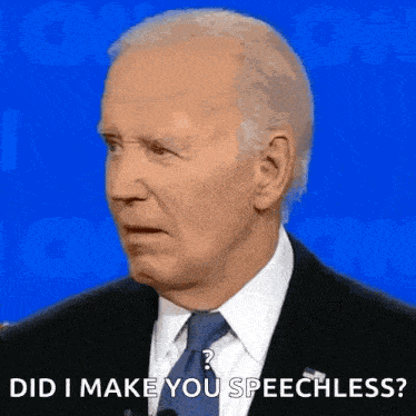 a man in a suit and tie is talking into a microphone and asking did i make you speechless .