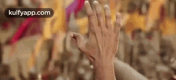 a close up of a person 's hands in the air .
