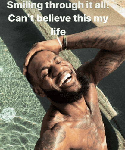 a shirtless man is smiling in front of a pool with the words smiling through it all can 't believe this my life