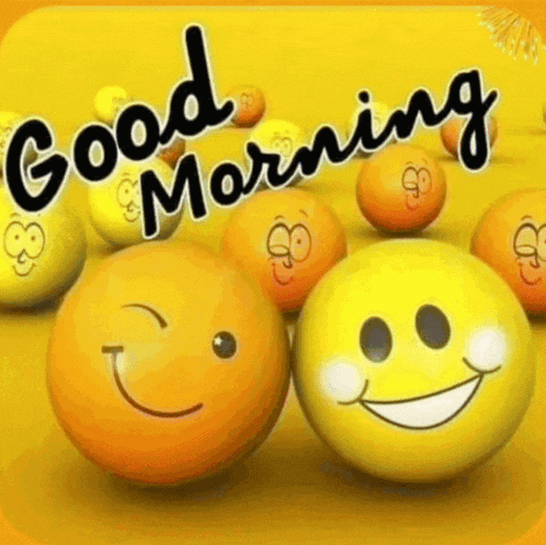 a group of yellow balls with smiley faces on them and the words good morning