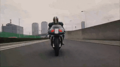 a man is riding a motorcycle down a highway