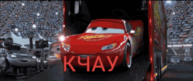 a red lightning mcqueen car is being loaded into a truck