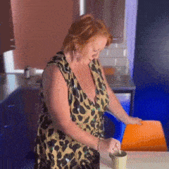 a woman in a leopard print dress is stirring a cup of coffee
